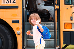 Boy boarding a school bus