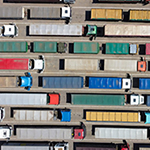 Many semi trucks waiting in lines